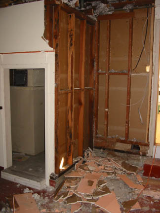 Even more of the wall next to the toilet is gone now.  Behind that wall are the water heater and furnace.