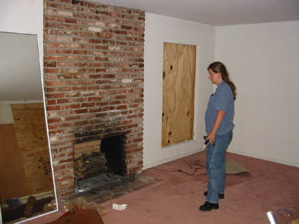 The wooden shelf above the fireplace has been removed now.