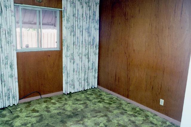 wood paneling, tiny window, metal awning visible outside.  Notice the Drapes of Mystery