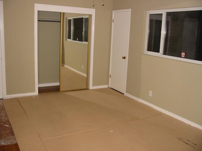 particle board covering in otherwise bare bedroom