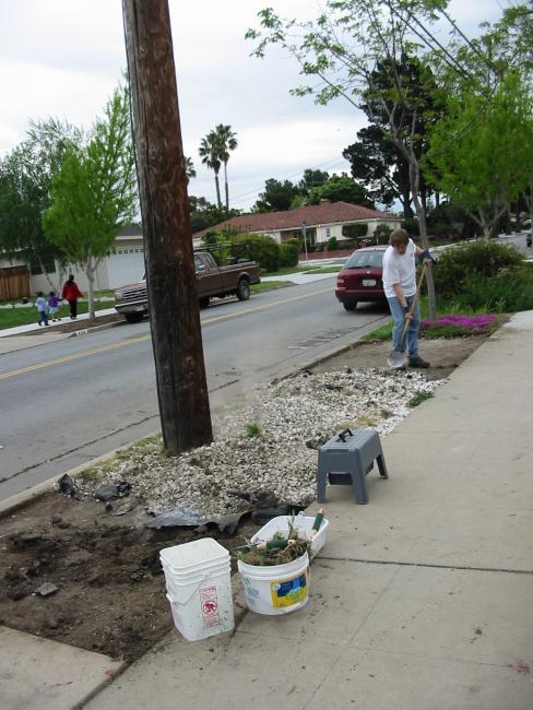 Vernon shovels white gravel in a pile