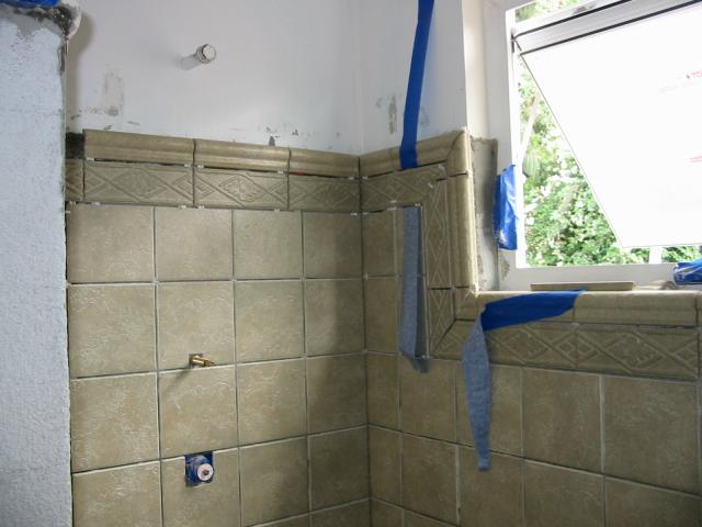 Shower stall with tile and a little plumbing